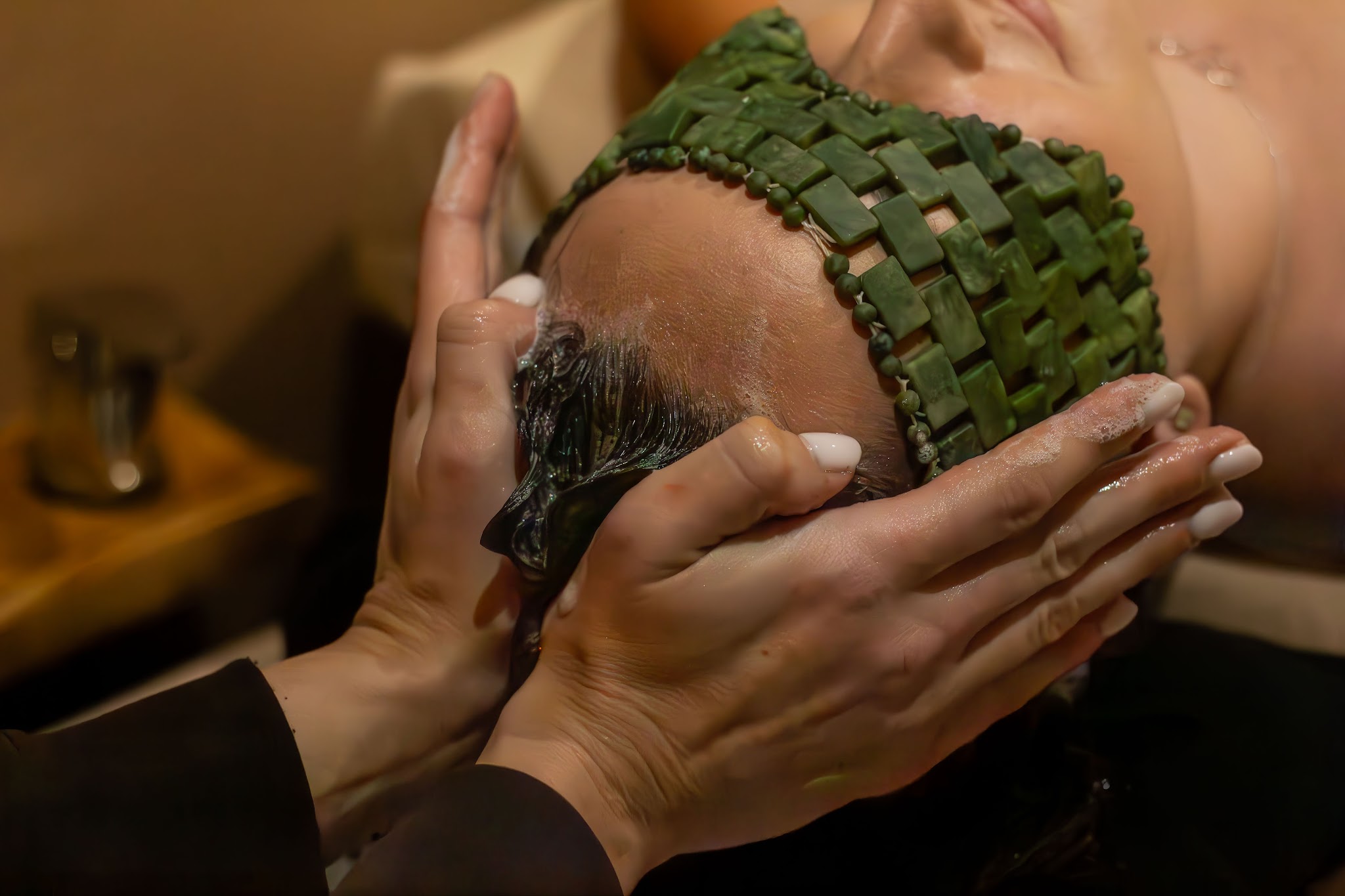 A head massage at Revitalise, the client wearing the green jade eye mask